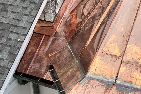 Image of a copper-topped spire on a roof, completed by Brose Construction.