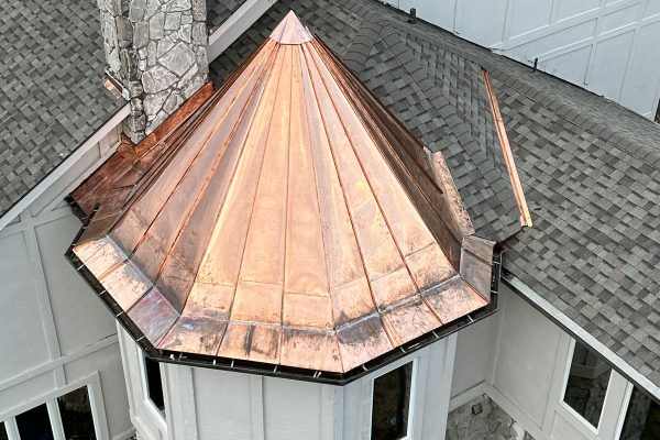 Image of a copper-topped spire on a roof, completed by Brose Construction.