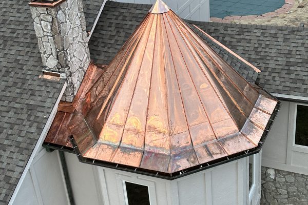Image of a copper-topped spire on a roof, completed by Brose Construction.