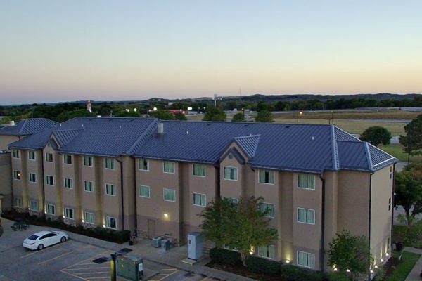 A large hotel with standing seam metal roofing installed by Brose Construction.