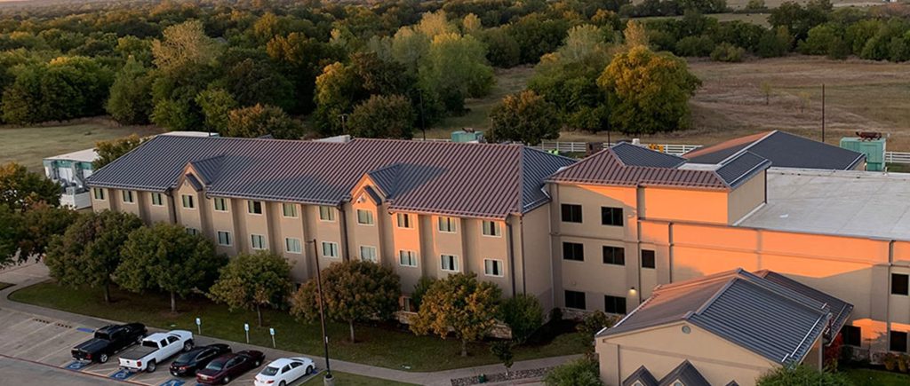 A large hotel with standing seam metal roofing installed by Brose Construction.