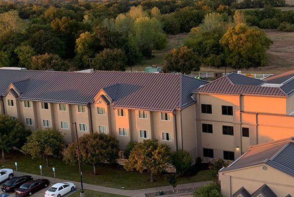A large hotel with standing seam metal roofing installed by Brose Construction.