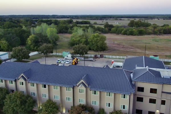 A large hotel with standing seam metal roofing installed by Brose Construction.