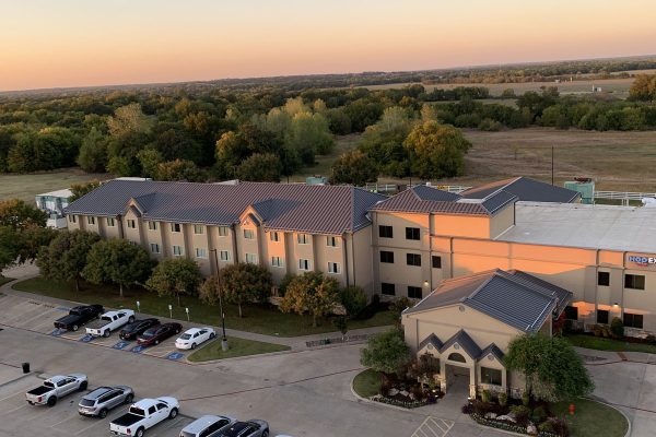 A large hotel with standing seam metal roofing installed by Brose Construction.