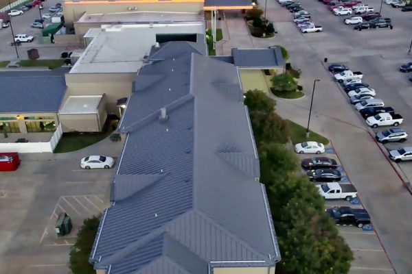 A large hotel with standing seam metal roofing installed by Brose Construction.